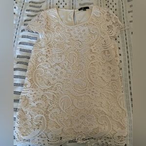 Small short sleeve blouse with a crochet overlay.